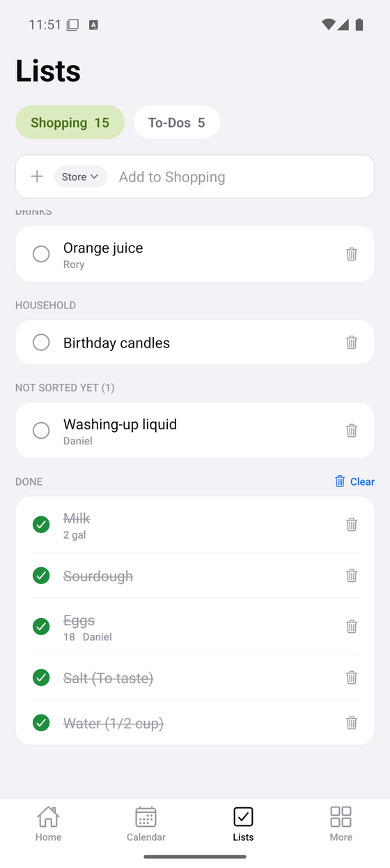 A shared shopping list grouped into drinks and household, with an item marked for one person.